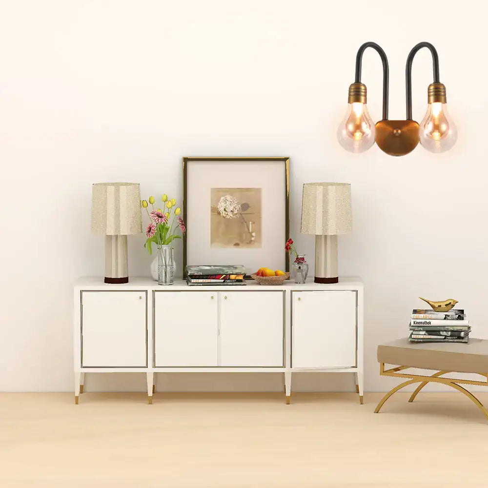 Industrial black and brass wall lamp with dual exposed filament bulbs and compact fixture width for bedroom lighting