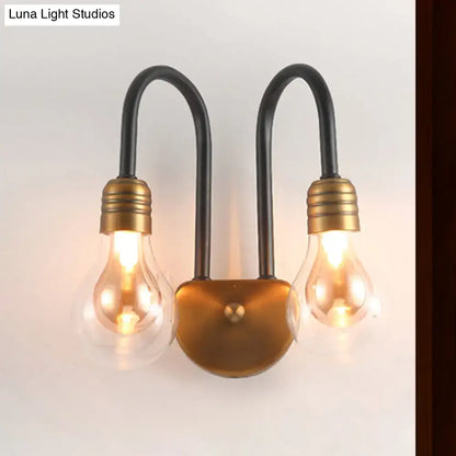 Industrial black and brass wall lamp with two arched arms and brass bulb sockets, ideal bedroom led light fixture
