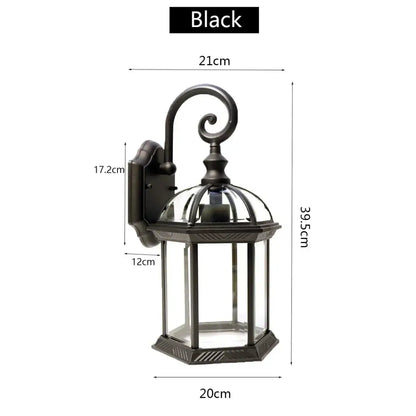 Black wrought iron wall lamp with clear glass panels and decorative curved arm decorbites black bronze wall lantern