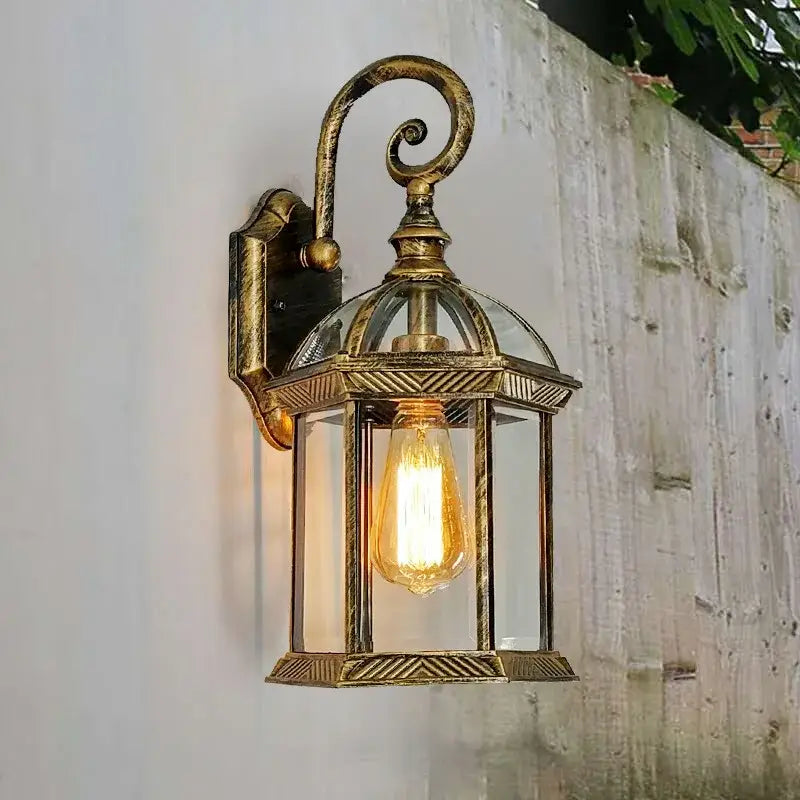 Antique brass-finished wall lamp with clear glass panels and exposed Edison bulb from decorbites black bronze wall collection