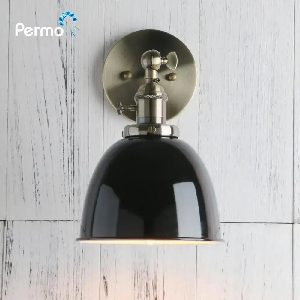Industrial black wall sconce with black enamel dome and brushed nickel adjustable arm for bedroom use