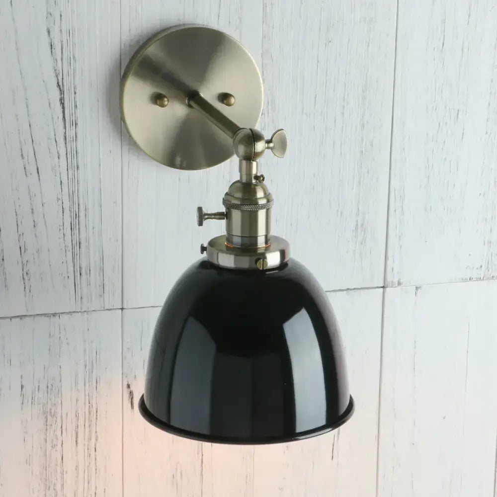 Industrial black wall sconce with black enamel dome lamp and brushed nickel adjustable arm for bedroom lighting