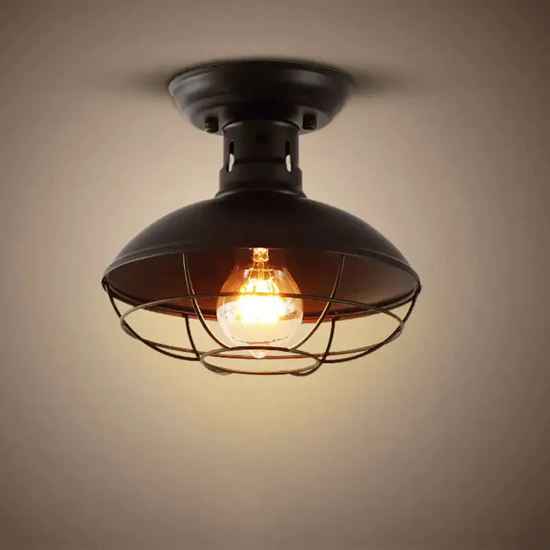 Black industrial ceiling light with dome shade and metal cage housing exposed filament bulb for decorbites industrial ceiling decor