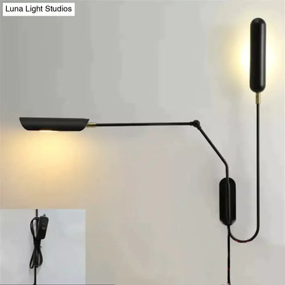 Black adjustable emma industrial wall lamp with sleek modern design and brass accents for bedroom reading light