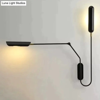 Black minimalist emma industrial wall lamp with sleek articulated arm and warm light for bedroom reading use