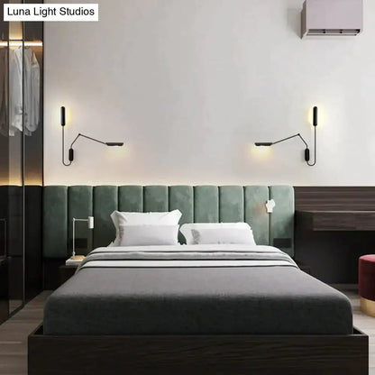 Modern black emma industrial wall lamp with articulated arms and warm-toned lighting for bedroom reading