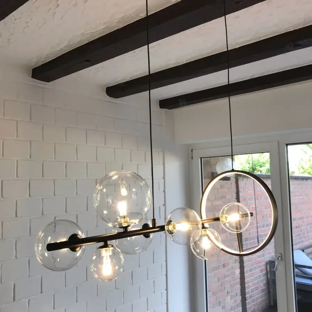 Modern black metal industrial glass bubble chandelier with clear globe bulbs and circular accent ring for dining decorbites glass bubble