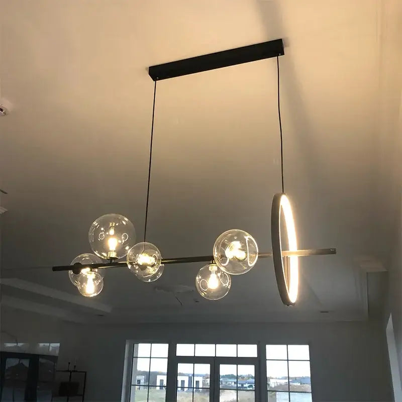 Modern black metal decorbites glass bubble chandelier with clear glass globe bulbs and circular ring accent for dining room