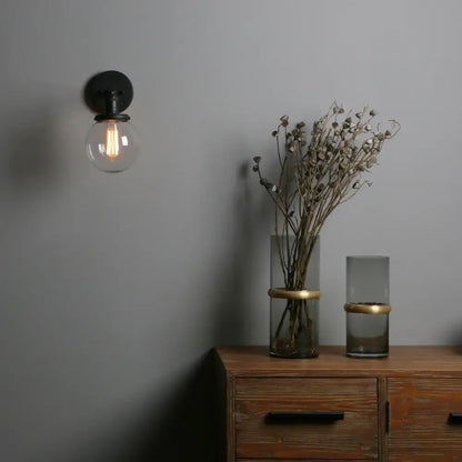 Industrial black glass canopy wall sconce with clear glass globe and exposed filament bulb for kitchen decorbites industrial glass