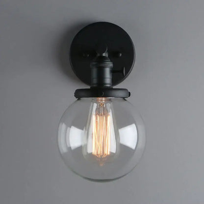 Industrial black glass canopy wall sconce with clear glass globe and exposed filament bulb for kitchen decorbites industrial glass