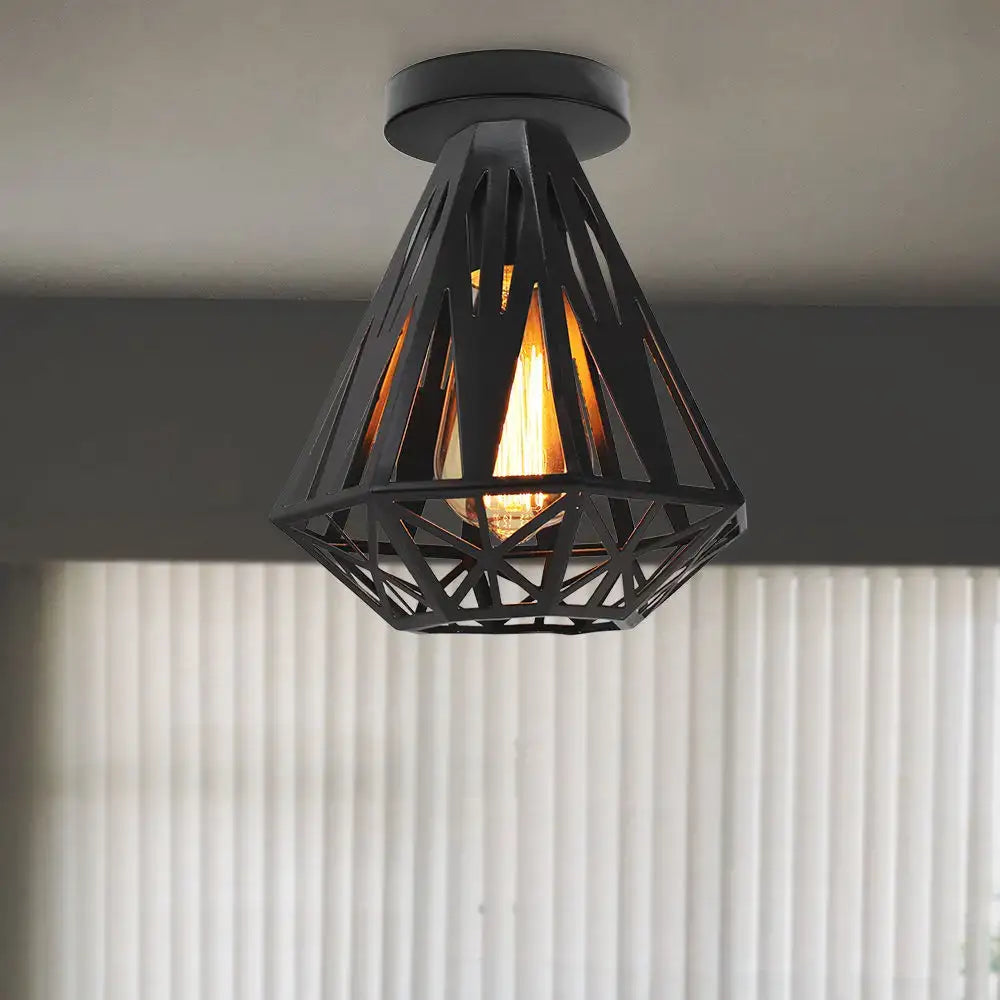 Industrial black iron aisle ceiling lamp featuring a black geometric metal cage and warm glowing filament bulb decorbites iron aisle
