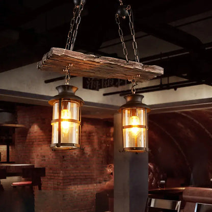 Rustic wooden beam suspending two black decorbites industrial pendant lights with clear glass and brass accents hanging lamps