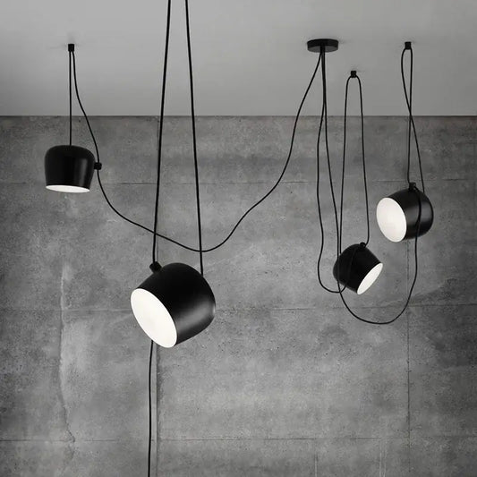 Industrial black matte spider pendant lamp with sleek cylindrical shades and exposed cords for dining room decorbites industrial spider