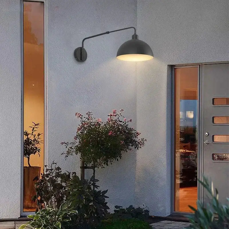 Dark gray industrial black matte wall lamp with dome shade and telescopic swing arm emitting warm light for living room
