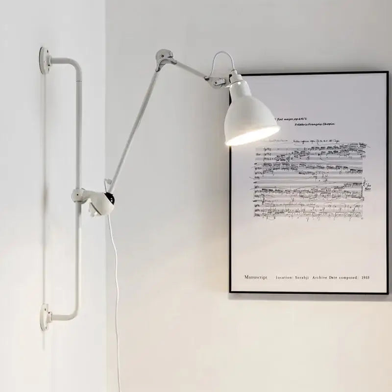 White adjustable wall lamp with articulated arms and matte finish ideal for bedroom reading decorbites gras style