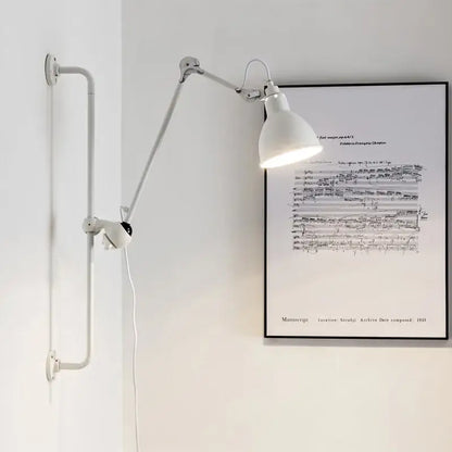 White adjustable wall lamp with articulated arms and matte finish ideal for bedroom reading decorbites gras style