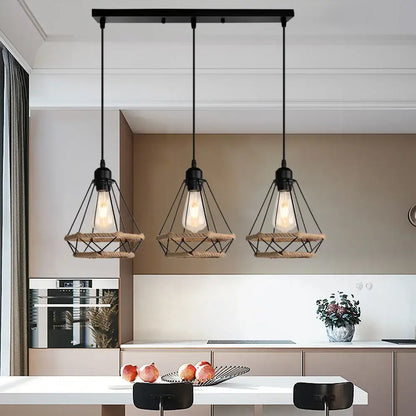 Three black industrial hanging lamps with metal and woven rope accents by decorbites above kitchen island