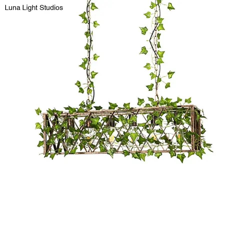 Rectangular industrial black metal cuboid plant island light fixture with rustic woven lattice and green ivy vines