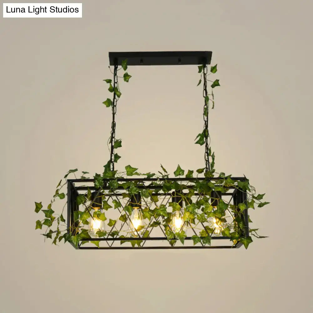 Black metal cuboid plant island light fixture with exposed bulbs and hanging green ivy vines for dining room use
