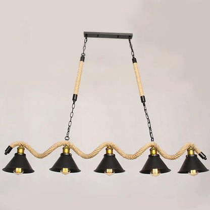 Industrial black metal island chandelier with five conical shades suspended by beige rope and brass accents