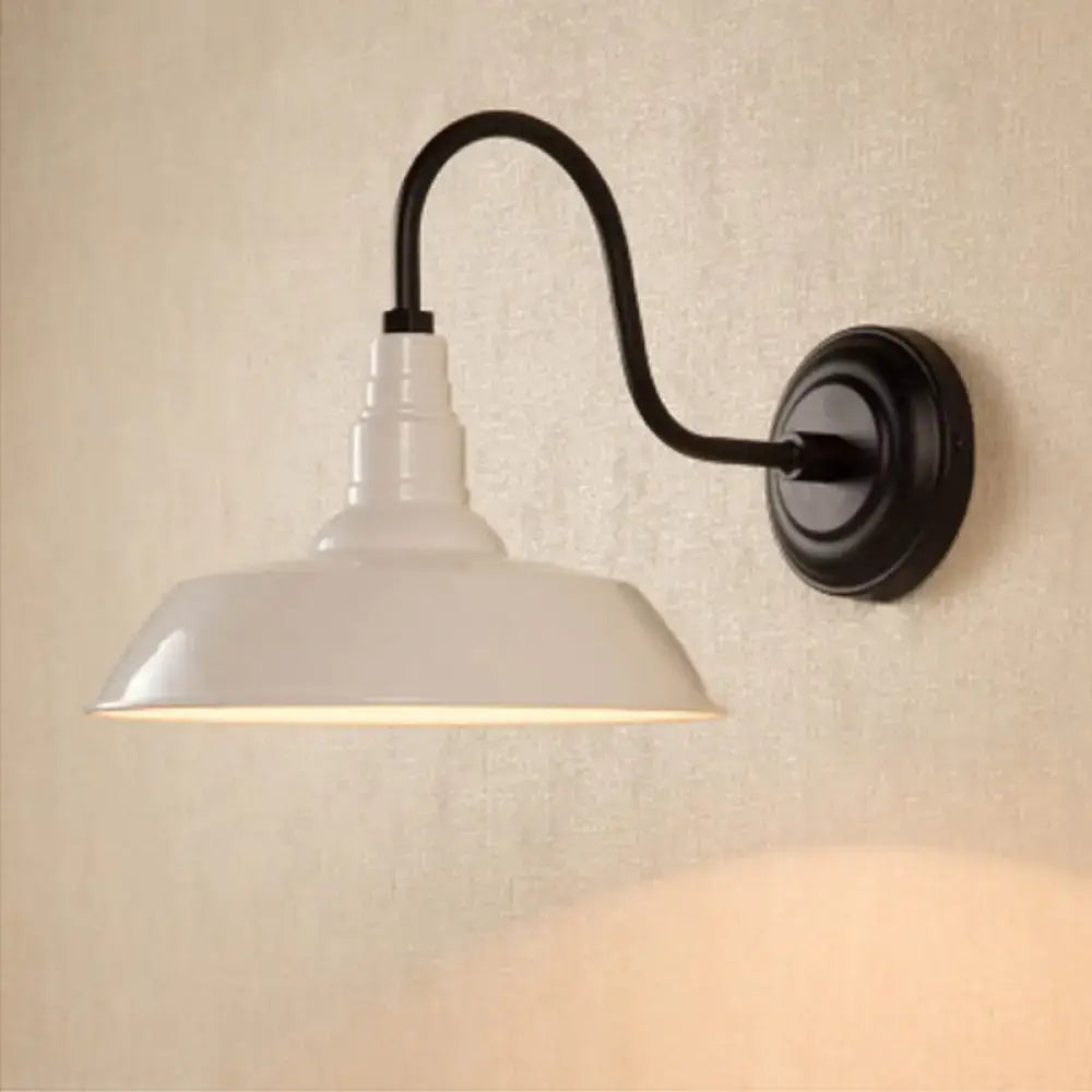 White enamel pendant wall light with black metal curved arm and circular base featuring an industrial metal shade design