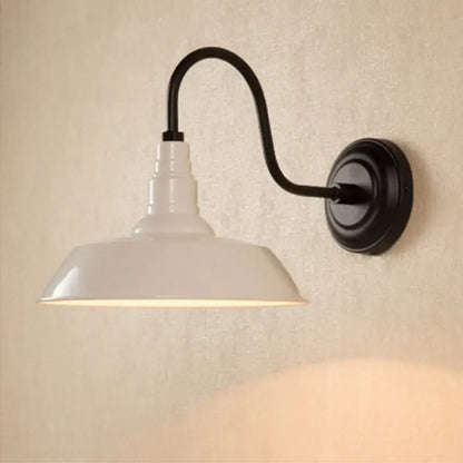 White enamel pendant wall light with black metal curved arm and circular base featuring an industrial metal shade design