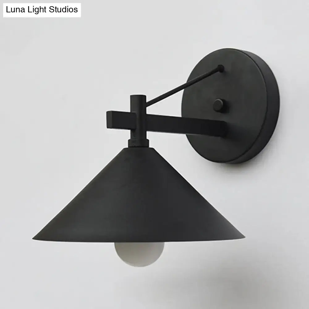 Black matte metal cone wall hanging light with a conical shade and minimalist geometric arm by DecorBites outdoor vintage sconce
