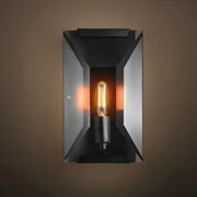 Industrial black metal wall mounted sconce light with a glowing Edison bulb for bedroom wall mounted lamp fixture