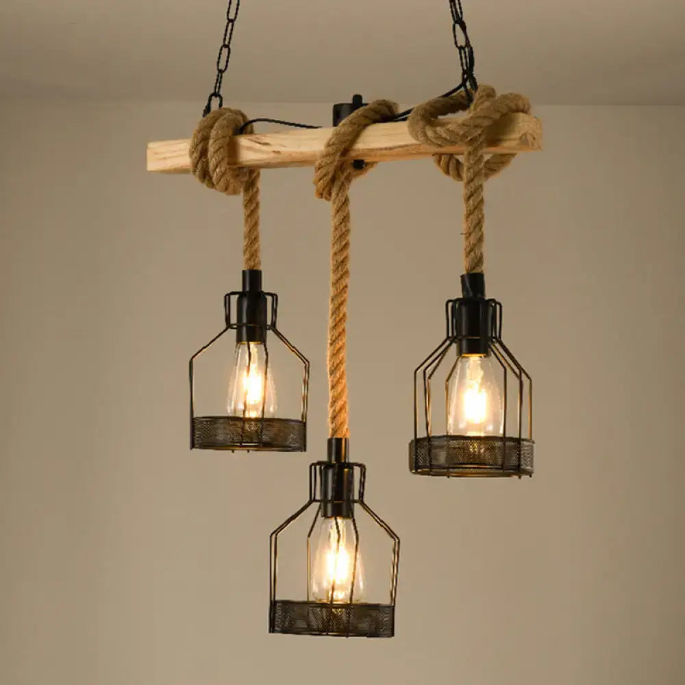 Industrial-style black metal metallic island pendant light fixture with three cage lamps and jute rope cord for dining room