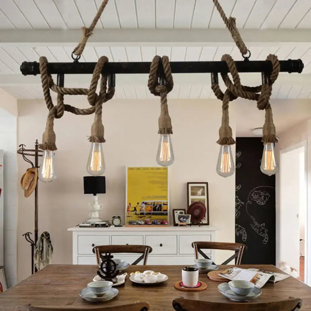 Industrial black pipe and rope chandelier with exposed filament bulbs for linear restaurant island lighting