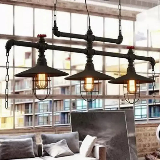 Industrial black pipe chandelier with three exposed filament bulbs and red valve caps for dining room lighting