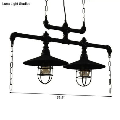 Industrial black pipe chandelier with two exposed bulbs and red valve caps suspended by chains for dining room lighting