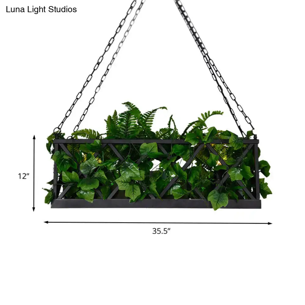 Black metal hanging planter with lattice design filled with artificial ferns beside DecorBites™ black rectangular island ceiling light fixture
