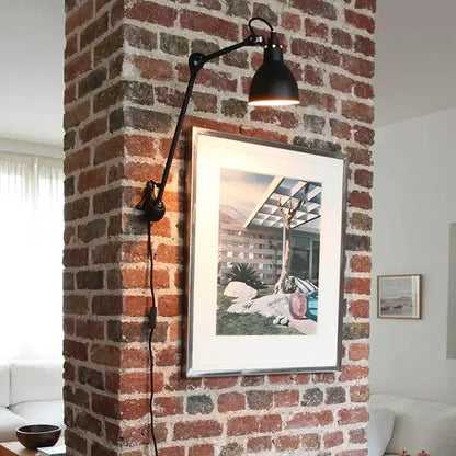 Black articulated wall lamp with matte finish and adjustable arm from decorbites industrial iron swing collection for bedroom decor