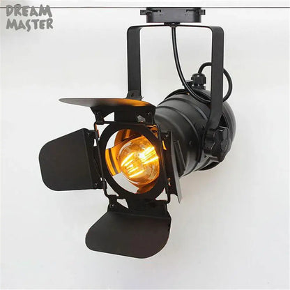 Industrial black spotlight rail light with adjustable barn doors and warm amber bulb for commercial store lighting decorbites industrial spotlight
