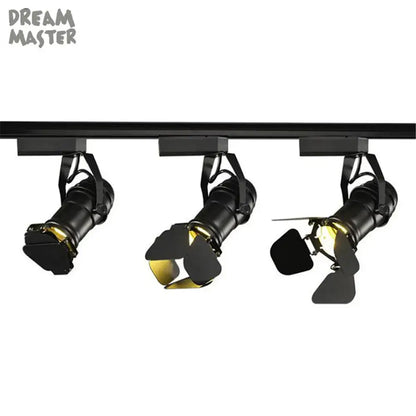 Industrial black spotlight rail light with adjustable gold-toned interiors for commercial store lighting decorbites industrial spotlight