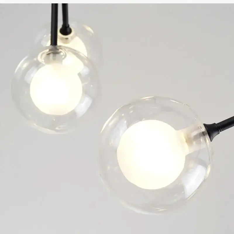 Clear glass globe pendant lights with black cords in industrial black tree branch glass ball firefly chandelier decorbites