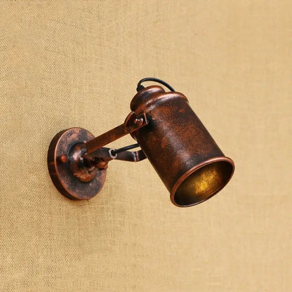 Antique bronze-finished industrial-style wall light with cylindrical shade and adjustable arm for vintage wall decorbites industrial vintage decor
