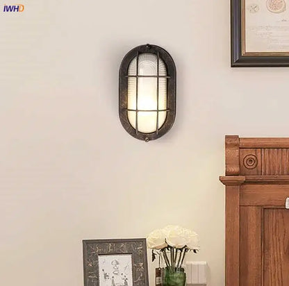 Vintage-style oval wall lamp with dark bronze metal frame and frosted glass panels for decorbites industrial glass wall lighting