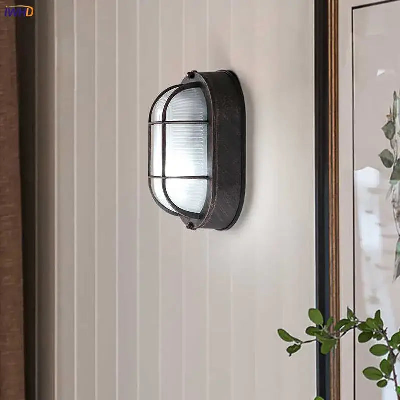 Black metal wall lamp with frosted ribbed glass panel and protective grid for stairway lighting decorbites industrial glass wall