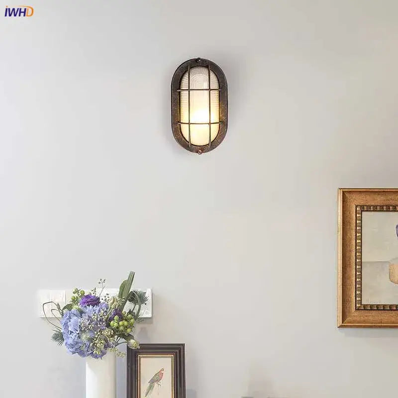 Vintage-style oval wall lamp with dark bronze metal frame and frosted glass panels for decorbites industrial glass