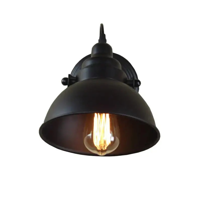 Industrial black wall sconce decorbites featuring a wrought iron dome shade and exposed filament bulb for bedroom use