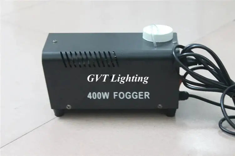 Industrial black and white 400w wireless remote fog machine with white cap and coiled black power cord for parties