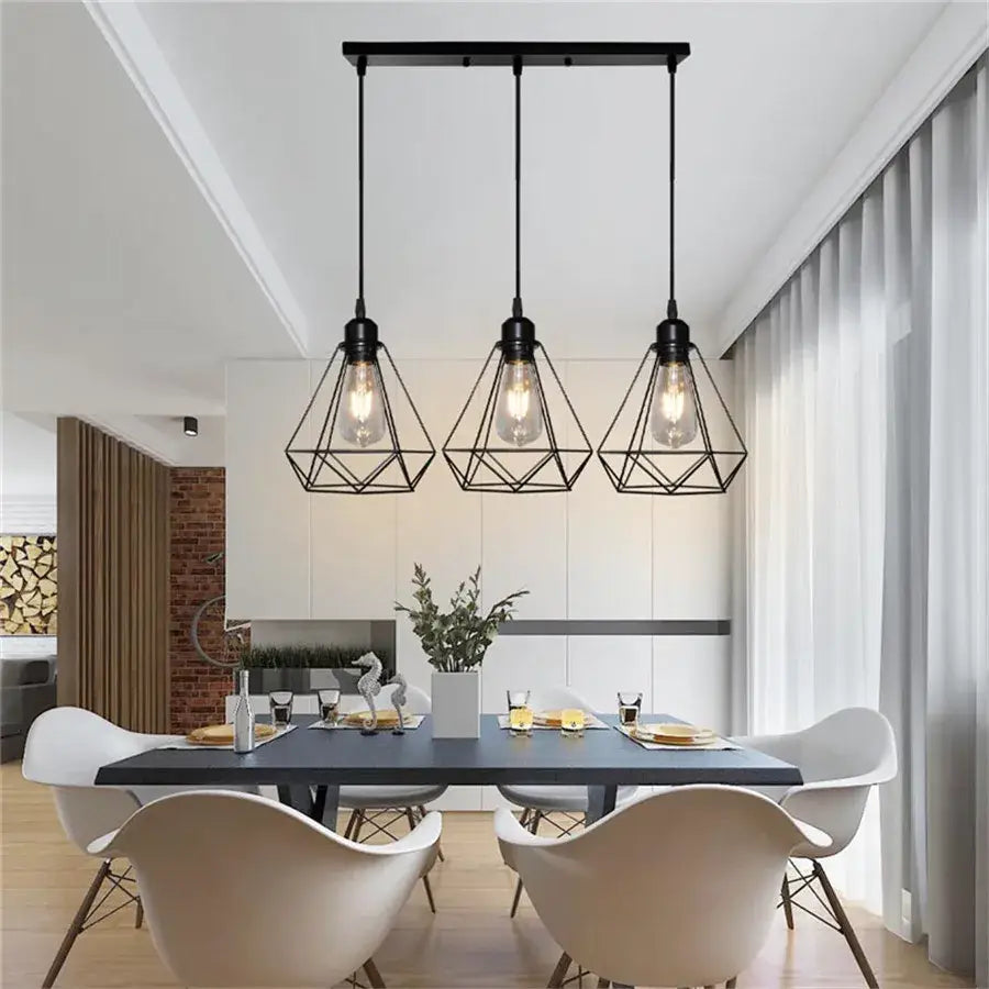 Industrial black diamond cage wrought iron pendant light with exposed filament bulbs hanging above dining table