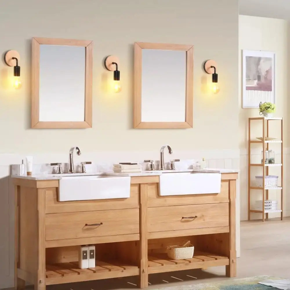 Light oak double sink vanity with white ceramic sinks and brushed nickel faucets paired with industrial led wall light decorbites