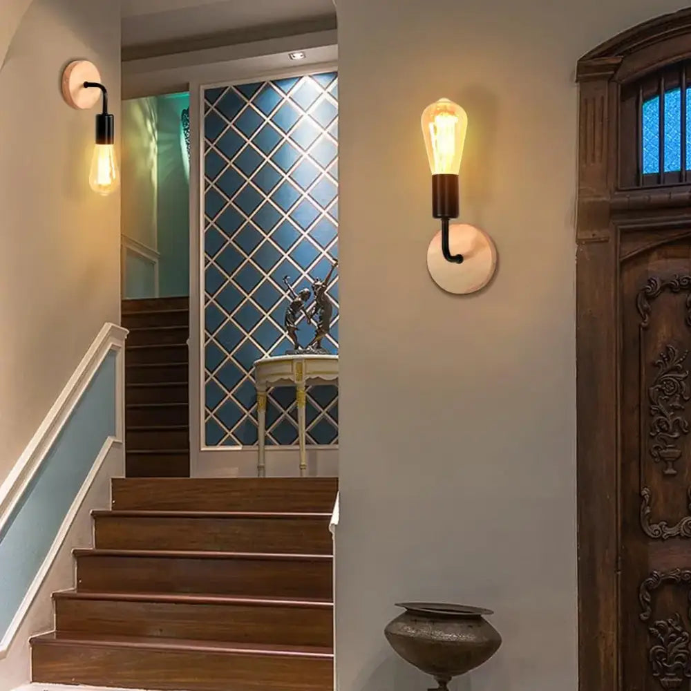 Warm-toned industrial led wall light featuring edison-style frosted glass bulb on black metal arm with off-white stone base