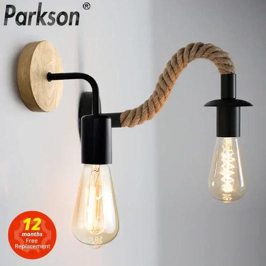 Parkson industrial black wall lamp with two exposed bulbs natural wood backplate and decorbites hemp rope wall detail