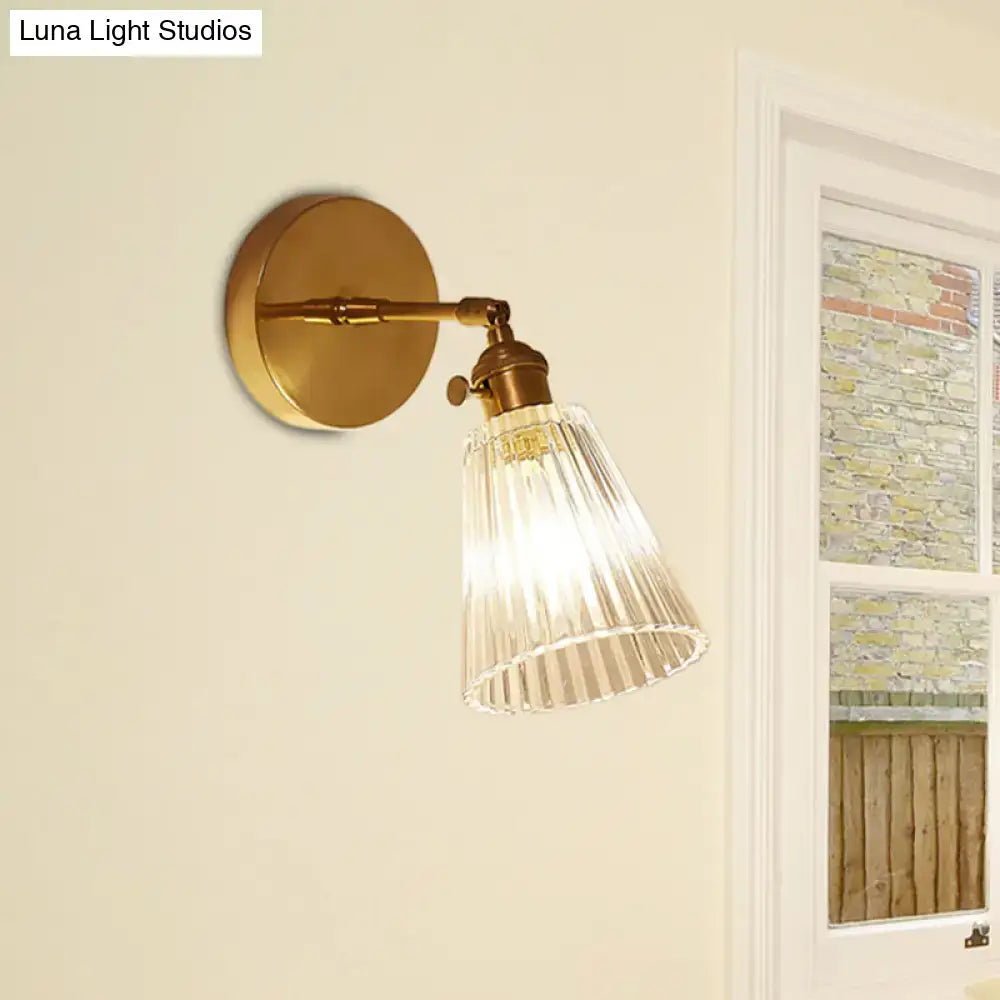 Decorbites clear textured glass wall sconce with gold-toned brass accents and clear textured glass shade for dining room lighting