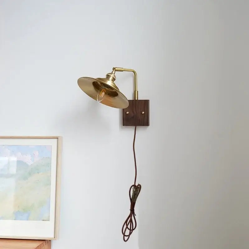 Industrial brass and walnut led wall light with a brass curved arm and dark wood base decorbites led wall bedroom sconce