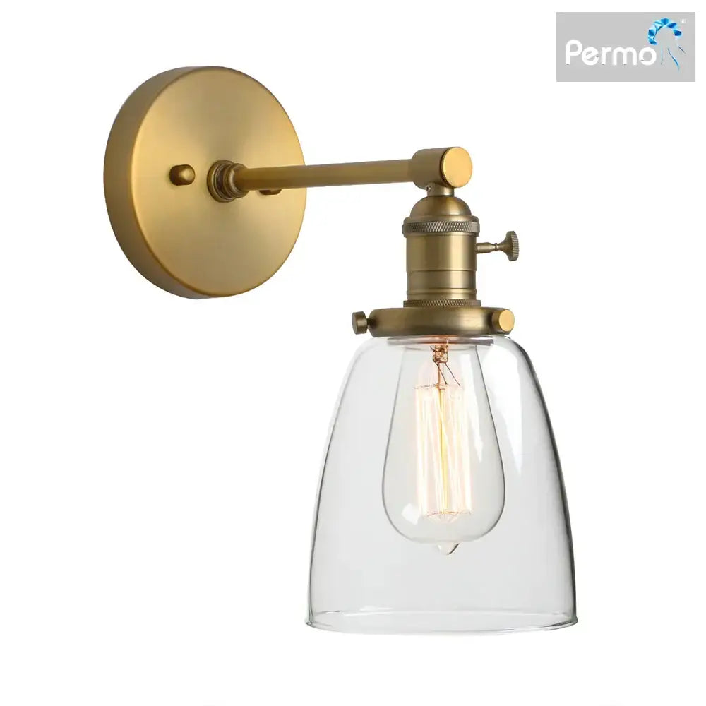 Industrial brass glass wall sconce light with clear bell-shaped shade and exposed filament bulb for bedroom use